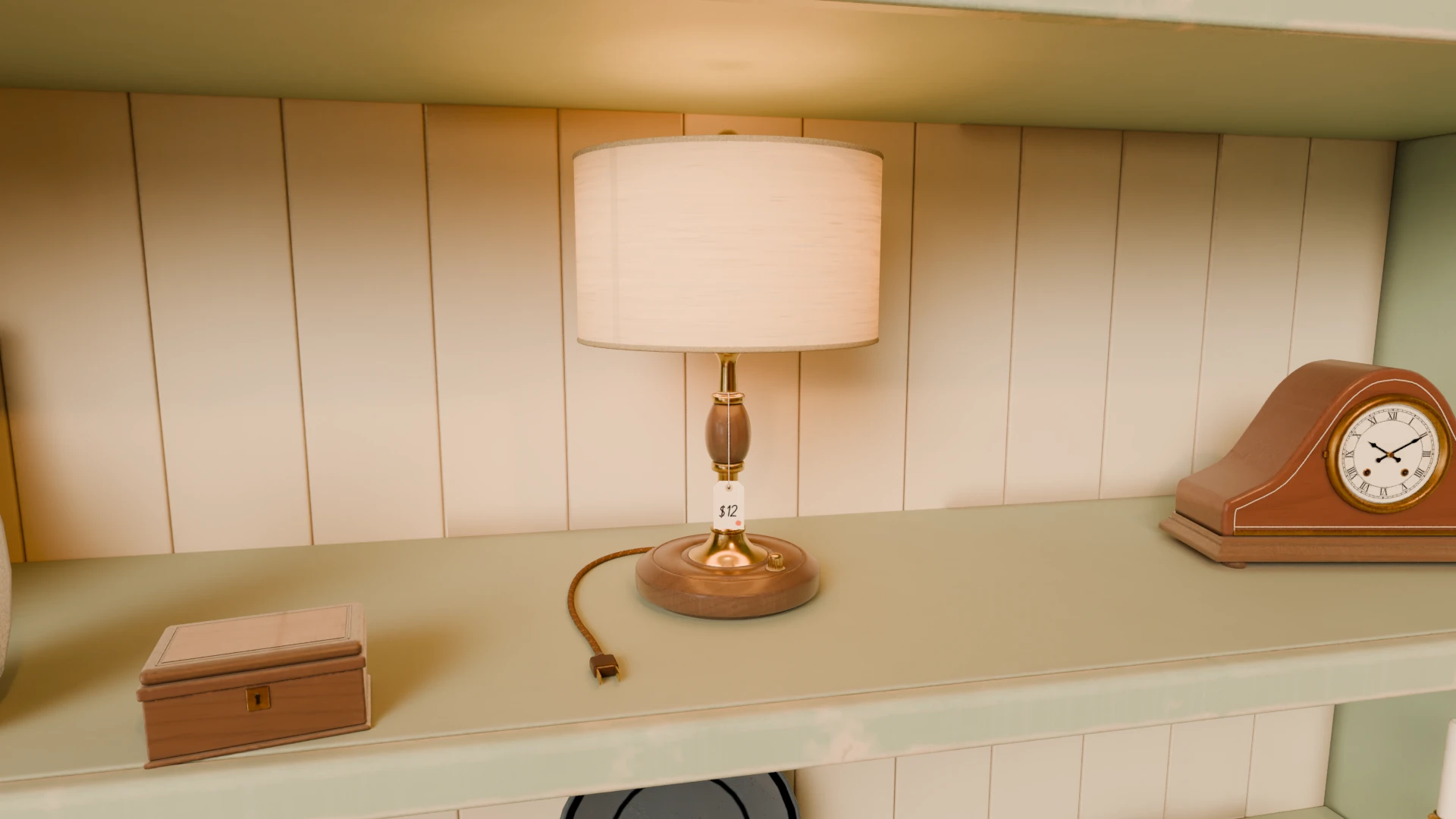 A brass table lamp with a $12 thrift tag on a shop shelf, beside a mantel clock and a jewelry box